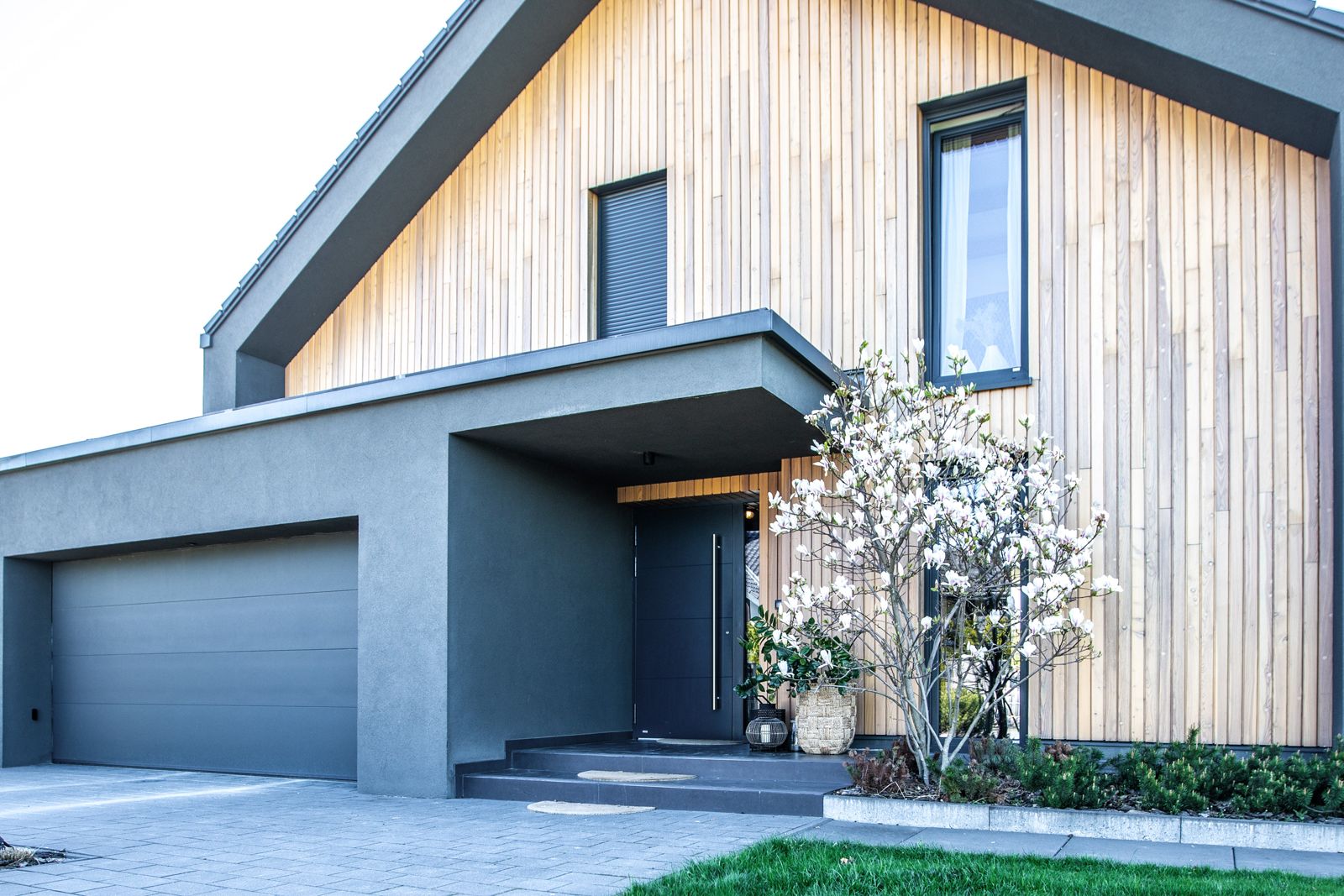 White house with matching grey garage door and front door