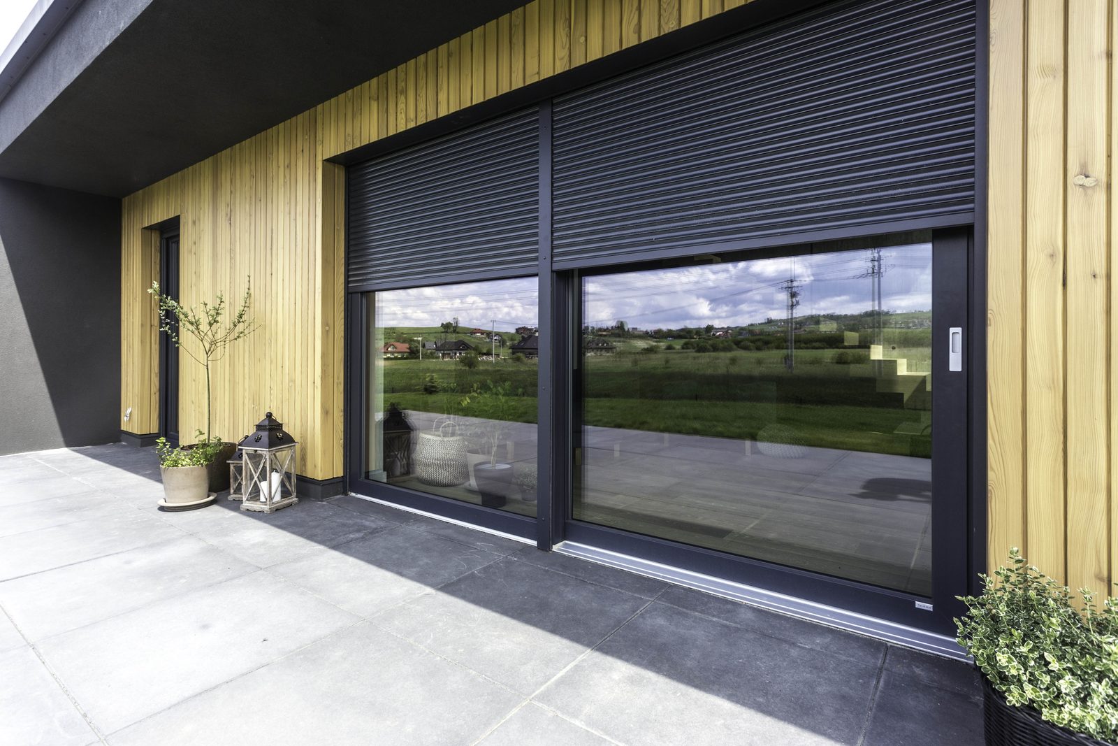 Roller shutters lowered over a large patio door