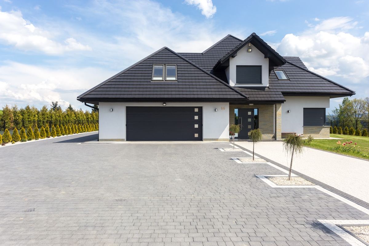 Dormer bungalow with a dark double garage door and matching front door