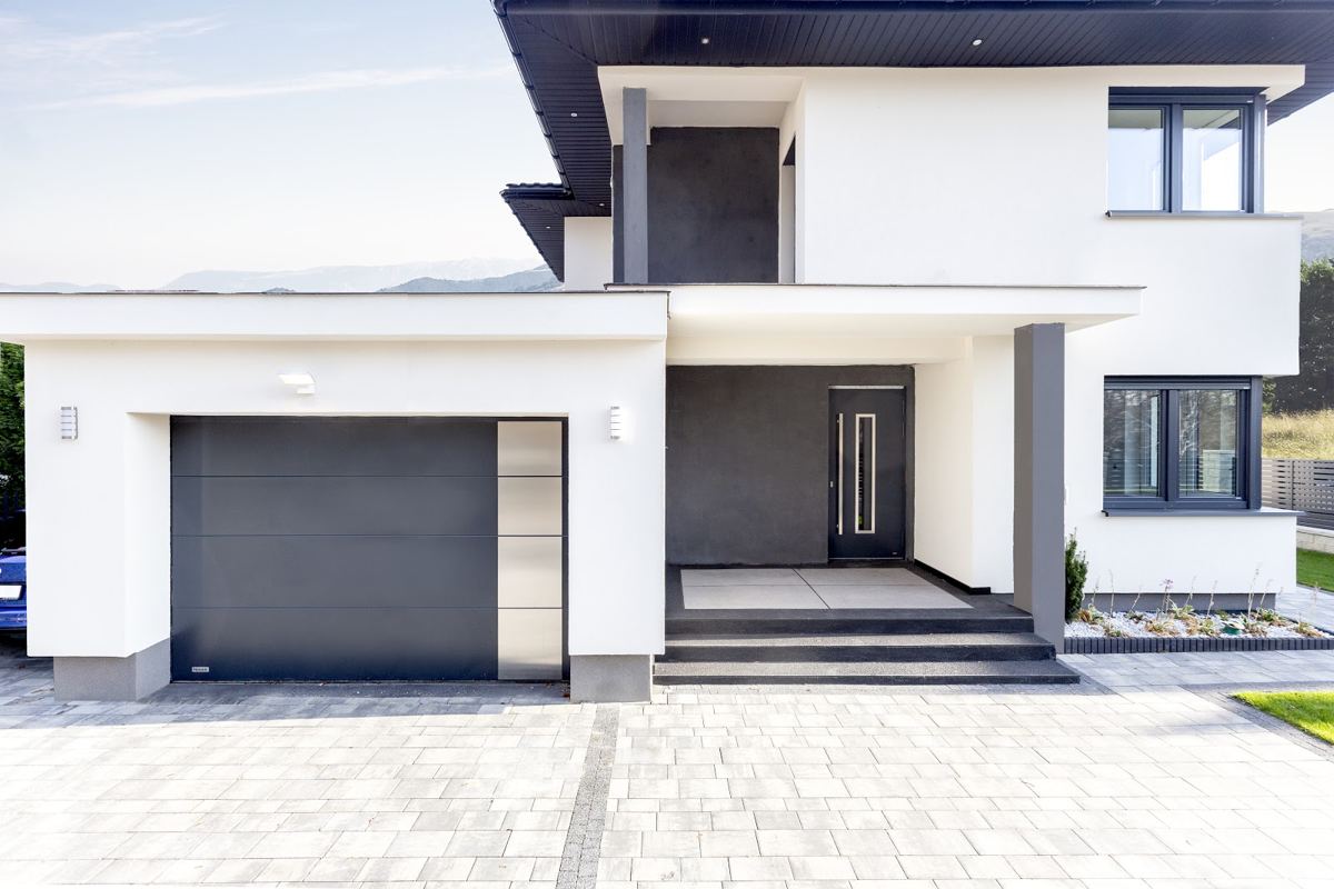 Modern white house with a graphite garage door and front door