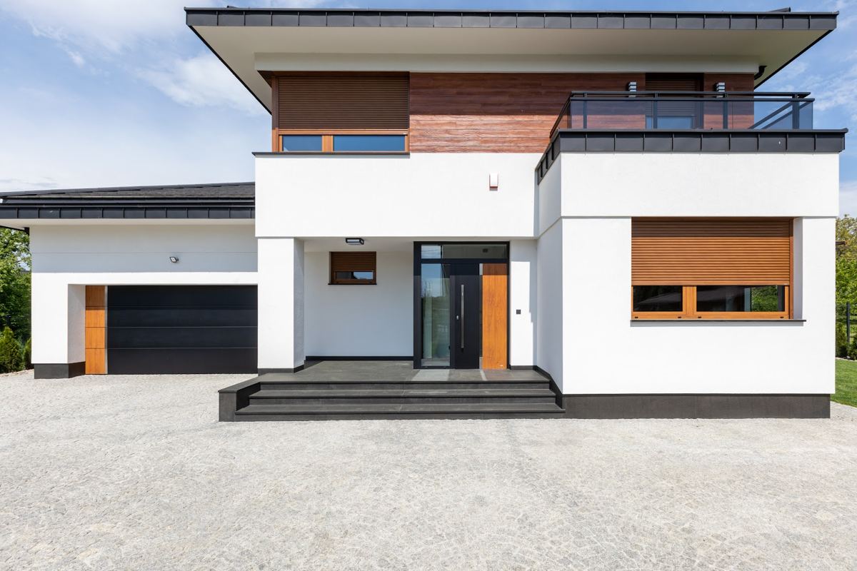 Flat-roof house with oak-effect windows and a dark garage door